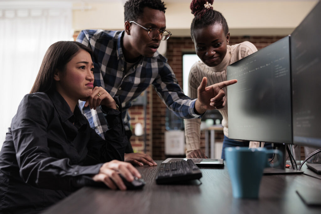 Cybersecurity Engineer discussing network threats with colleagues