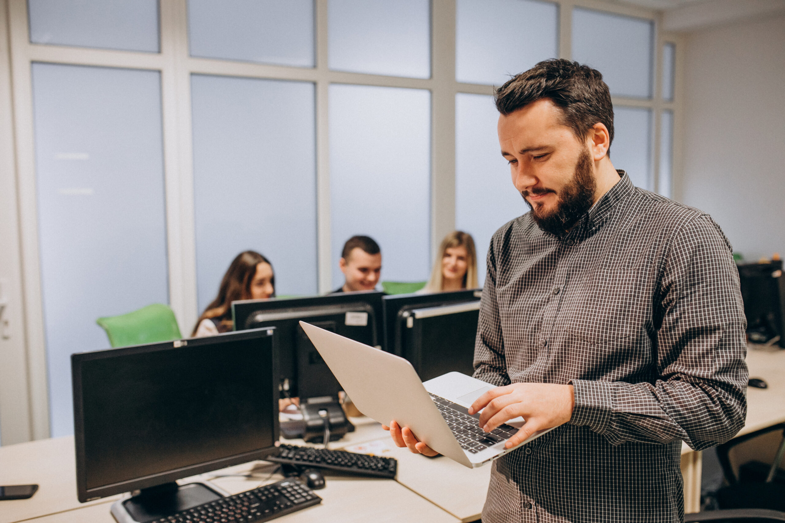 Data Analysts working at an IT company working on a computer