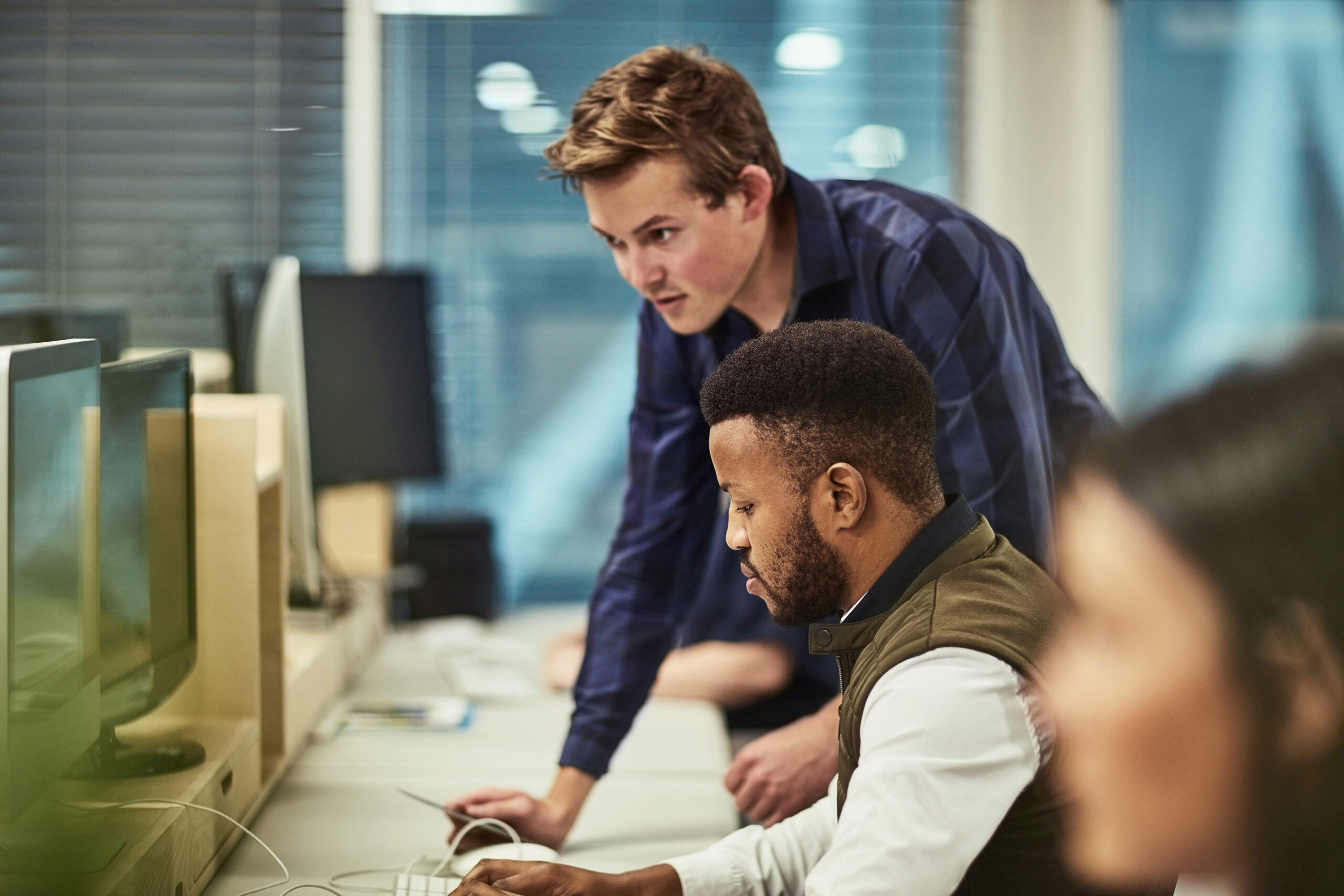 Shot of a group of DevOps Engineers working on computers in an office.